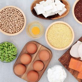 An overhead shot of a variety of food items that are high in protein. 