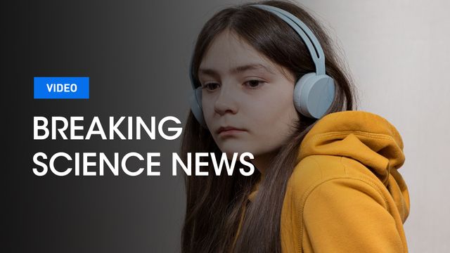 A young girl looking sad wearing headphones with the Breaking Science News logo over the top. 